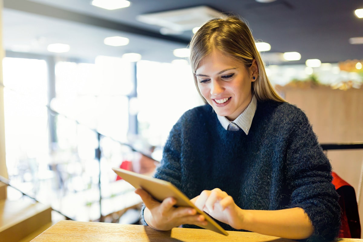 person using tablet to read blogs